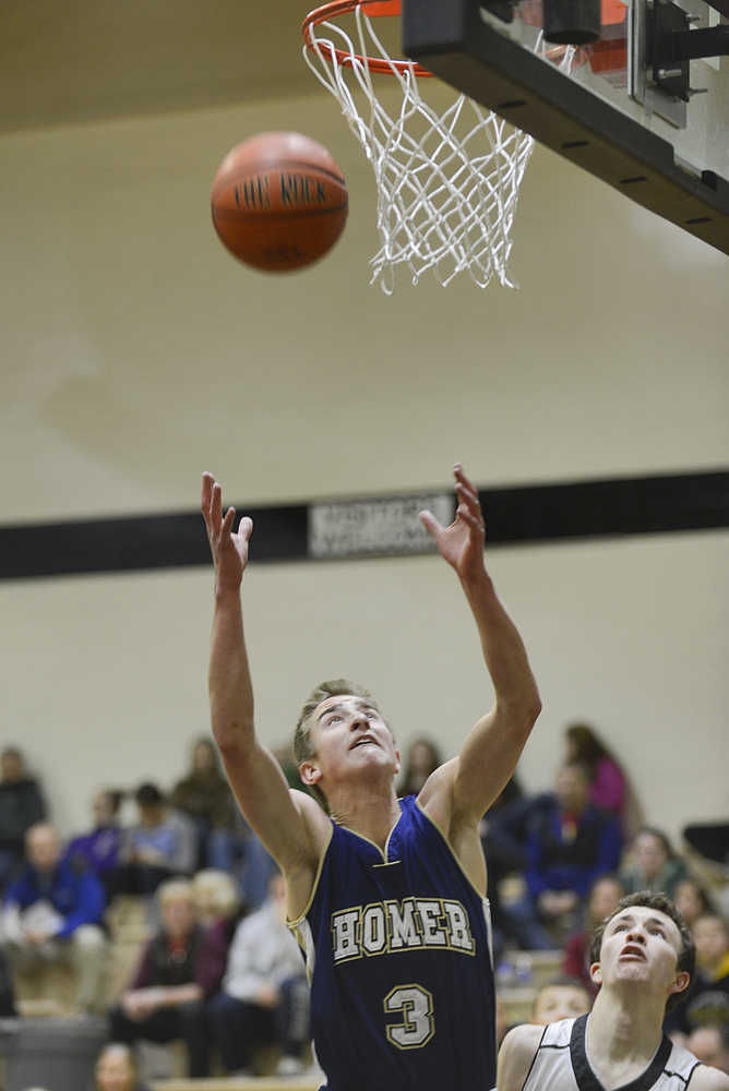 Photo by Rashah McChesney/Peninsula Clarion Homer's Brandon Beachy grabs a rebound during their game against Nikiski on Saturday Jan. 10,  2015 at Nikiski Middle-High School in Nikiski, Alaska.