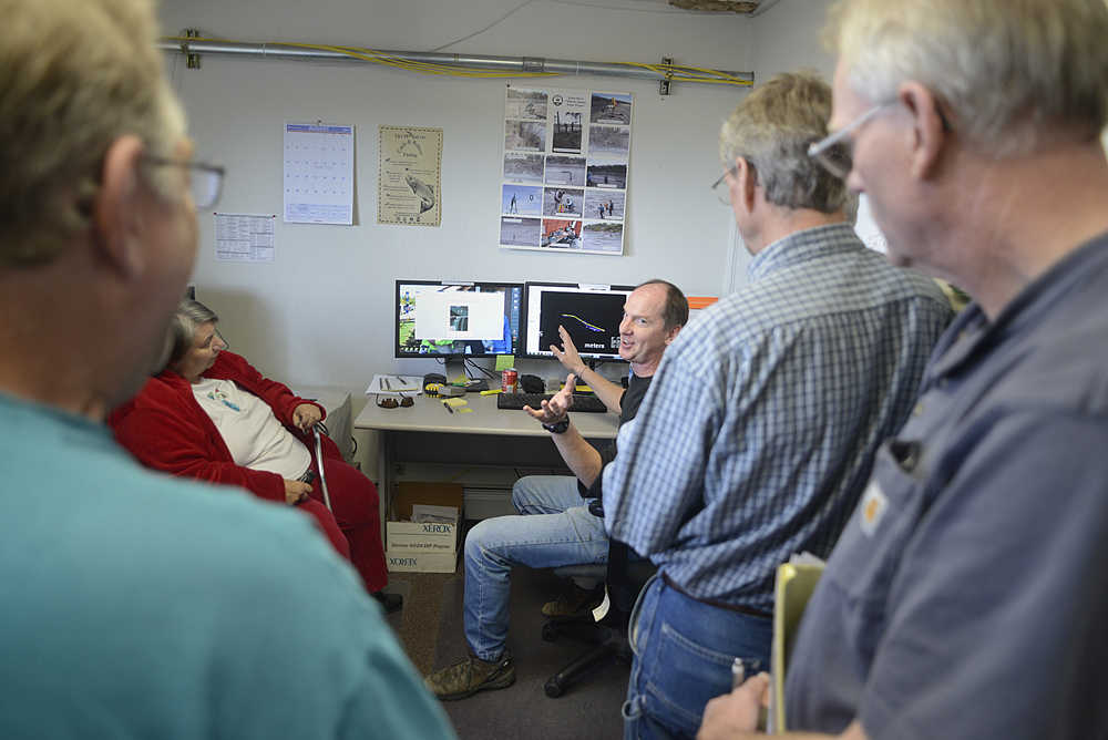 Photo by Rashah McChesney/Peninsula Clarion  Research biologist Jim Miller chats with a group about the Alaska Department of Fish and Game's sonar projects on the Kenai River Thursday August 15, 2013 in Kenai, Alaska. Several in the group had questions about the veracity of the department's chinook salmon measuring programs on the Kenai River.