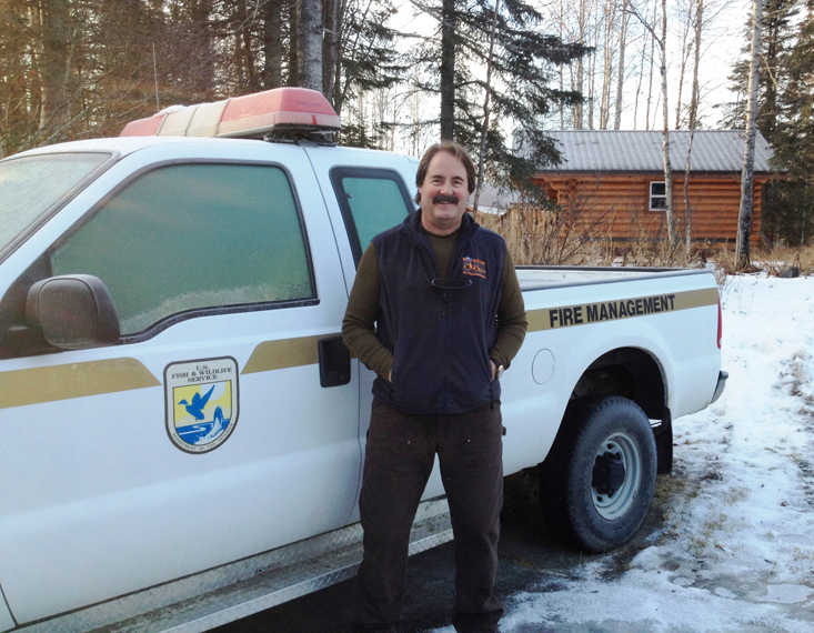 Now-retired Doug Newbould stands next to his Fire Management Vehicle. (Photo courtesy Kenai National Wildlife Refuge)
