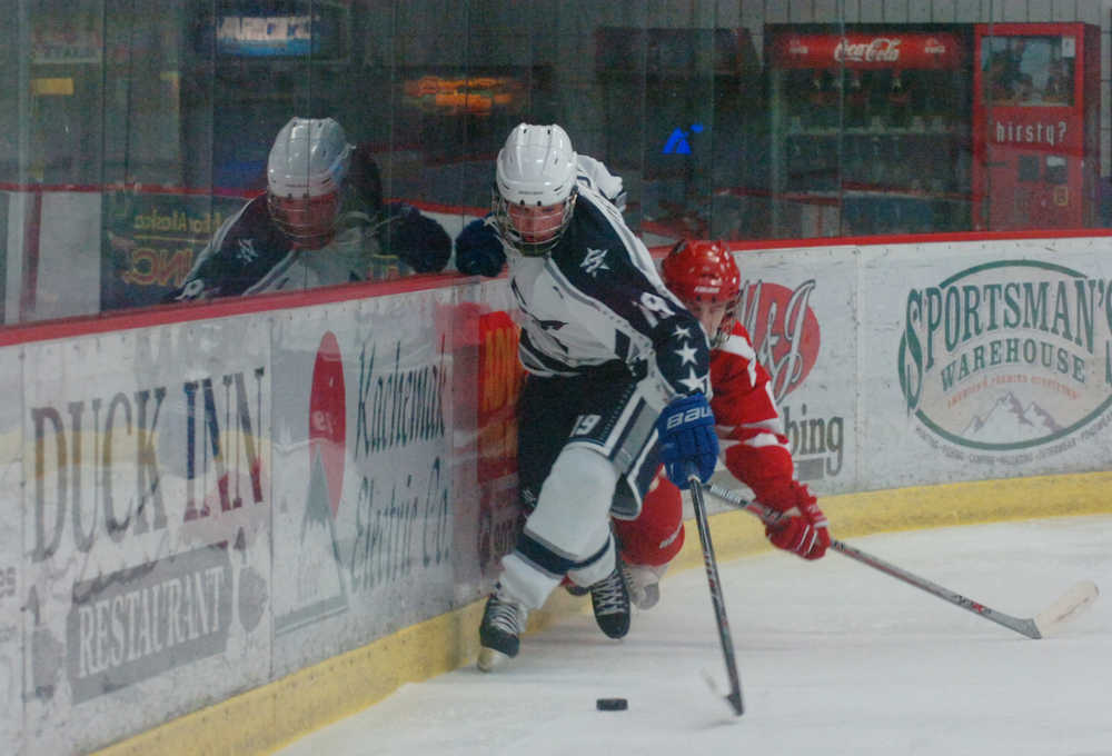 Photo by Kelly Sullivan/ Peninsula Clarion Soldotna High School Stars' Coel Nelson takes control of the puck behind the Wasilla Colony High School Knights goal, Thursday, January 15, 2015, at the Soldotna Regional Sports Complex in Soldotna, Alaska.