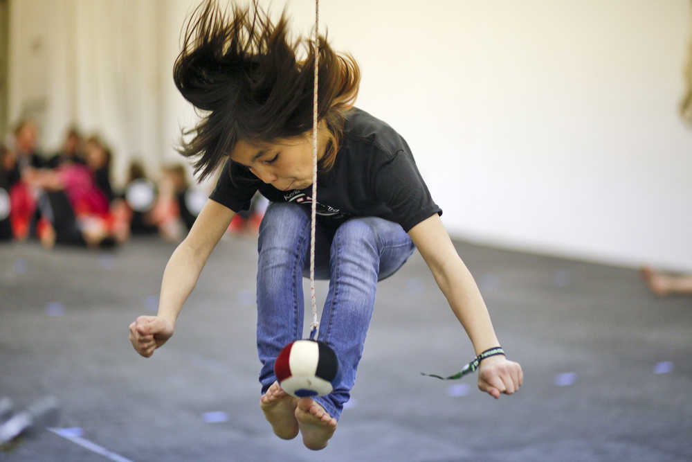 Photo by Rashah McChesney/Peninsula Clarion  Ransom Hayes, 9, competes against William Wilson, 9, as the two practice for the Native Youth Olympics event the arm pull on Wednesday Jan. 14, 2015 at the Kenaitze Indian Tribe's Yaghanen Youth Center in Soldotna, Alaska.