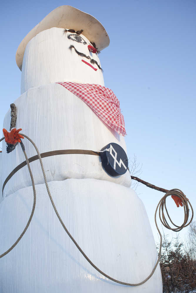 Photo by Rashah McChesney/Peninsula Clarion  A plastic-wrapped snowman cowboy faces Kalifornsky Beach Road in front of the Diamond M Ranch Resort in Kenai, Alaska. Carrol Martin, who owns the ranch, said he puts up snowmen pretty often. Carrol's wife, JoAnne Martin, said her husband often puts the snowmen up - but typically uses snow.  "He's built gobs of them over the years," she said.  Carrol said he'd take the hay-filled snowman down in the spring and spread the hay for his livestock to eat.