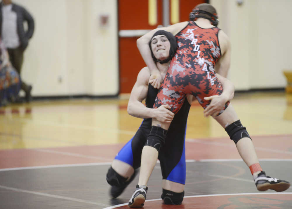 Photo by Kelly Sullivan/ Peninsula Clarion Soldotna High School Star James Gallagher tries to knock Kenai Central High School Kardinal Dylan Carter off his feet during the 182 weight-class match, Thursday, Jan. 22, 2015, at Kenai Central High School in Kenai, Alaska.