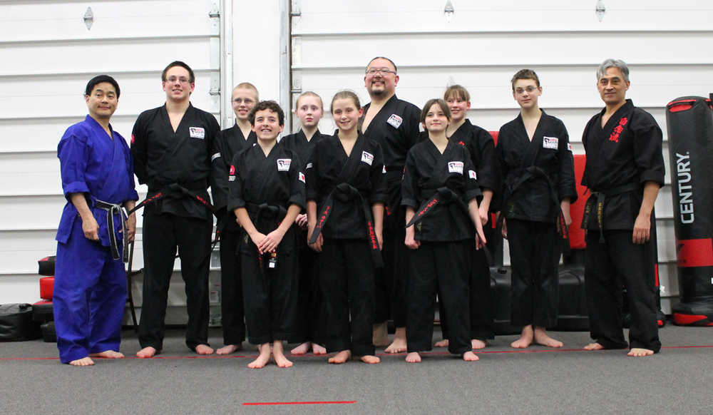 Submitted photo Pictured after black belt testing at Peninsula Martial Arts are, from left, Okamoto Sensei of Okamoto's School of Karate, new black belts Billy Morrow, Taylor Beile, Ryder Giesler, Andrea Beile, Rhys Cannava, Dr. Jerry Hu, Amelia Mueller, Grace Morrow and Tucker Mueller, and Peninsula Martial Arts owner and instructor Mike Hancock.