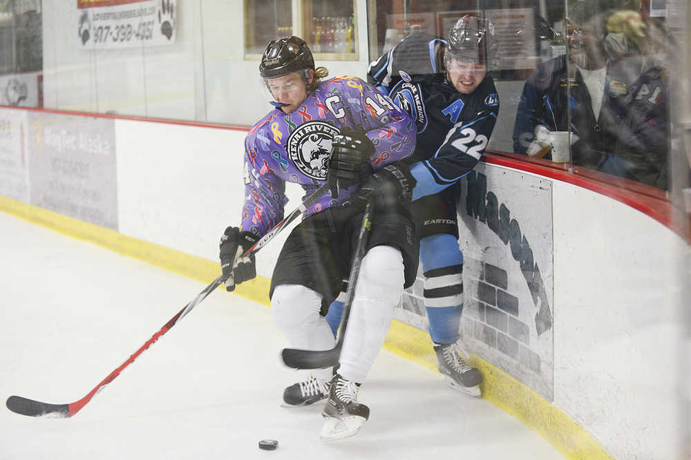 Photo by Rashah McChesney/Peninsula Clarion  Kenai River Brown Bears Austin Chavez slams Coulee Region Chill's Richard Zehnal into the glass, causing a beer to spill, during their game on Friday Jan. 23, 2014 in Soldotna, Alaska.