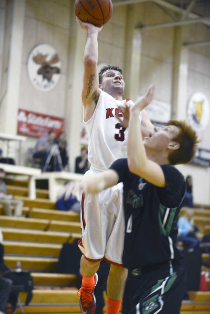 Photo by Rashah McChesney/Peninsula Clarion  Kenai Central High School Trevor Shirnberg lands a layup during their game against Palmer on Saturday Jan. 23, 2014 in Kenai, Alaska.