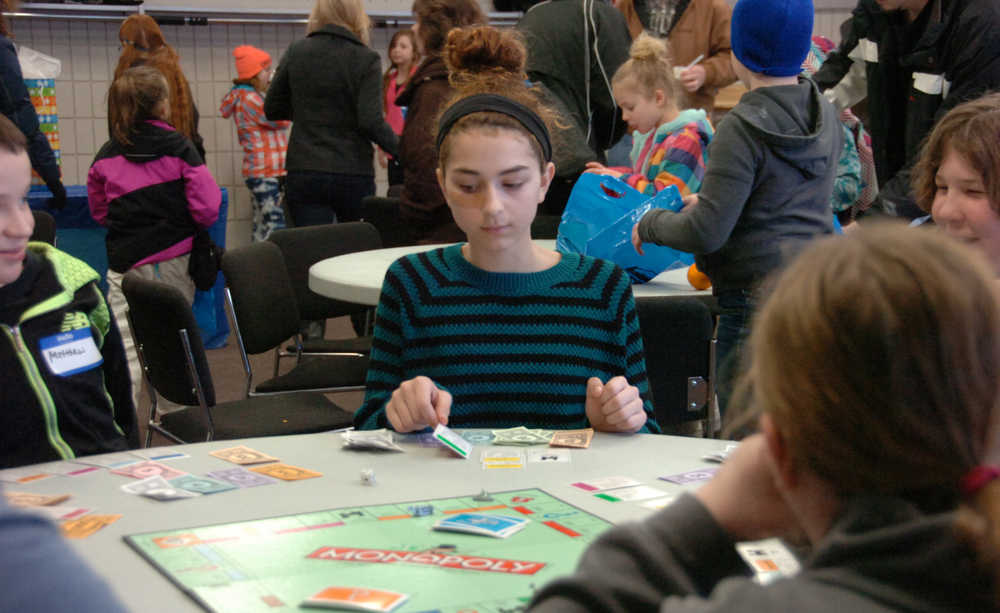 Ben Boettger/Peninsula Clarion Leah English considers a move at the Winter Games Monopoly tournament at the Soldotna Sports Complex on Saturday, Jan. 24.