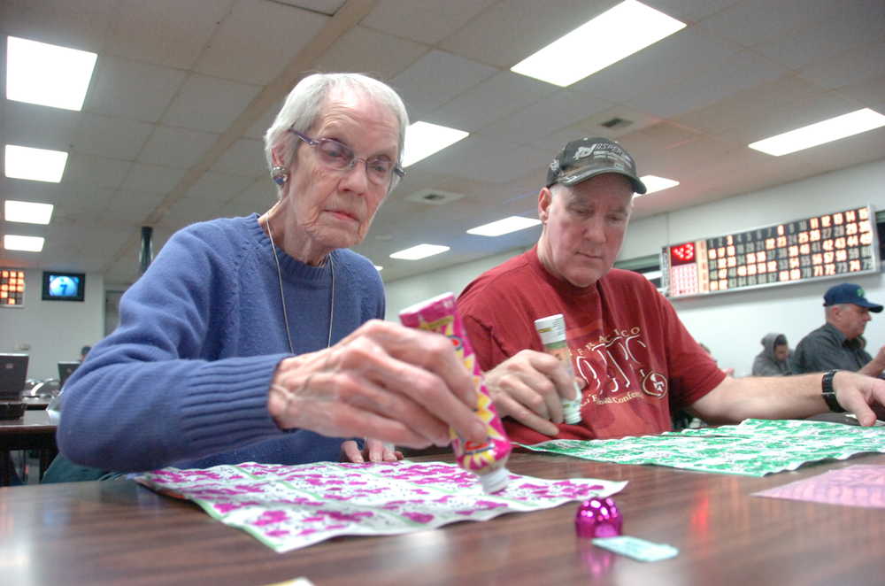 Photo by Kelly Sullivan/ Peninsula Clarion Barbara Aase and her son Scott Aase near the end of a game Tuesday at the Peninsula Oilers Baseball Club/ Bingo Hall in Kenai, Alaska. The two play at the hall between two and three times per week Scott Aase said. "Sometimes you win, not very often though. It helps you practice hand eye coordination," Scott Aase said.