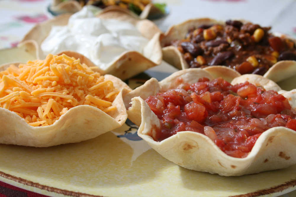 To keep baked tortilla shells from becoming soggy, fill with chili toppings, such as salsa, cheese and sour cream, just before serving.