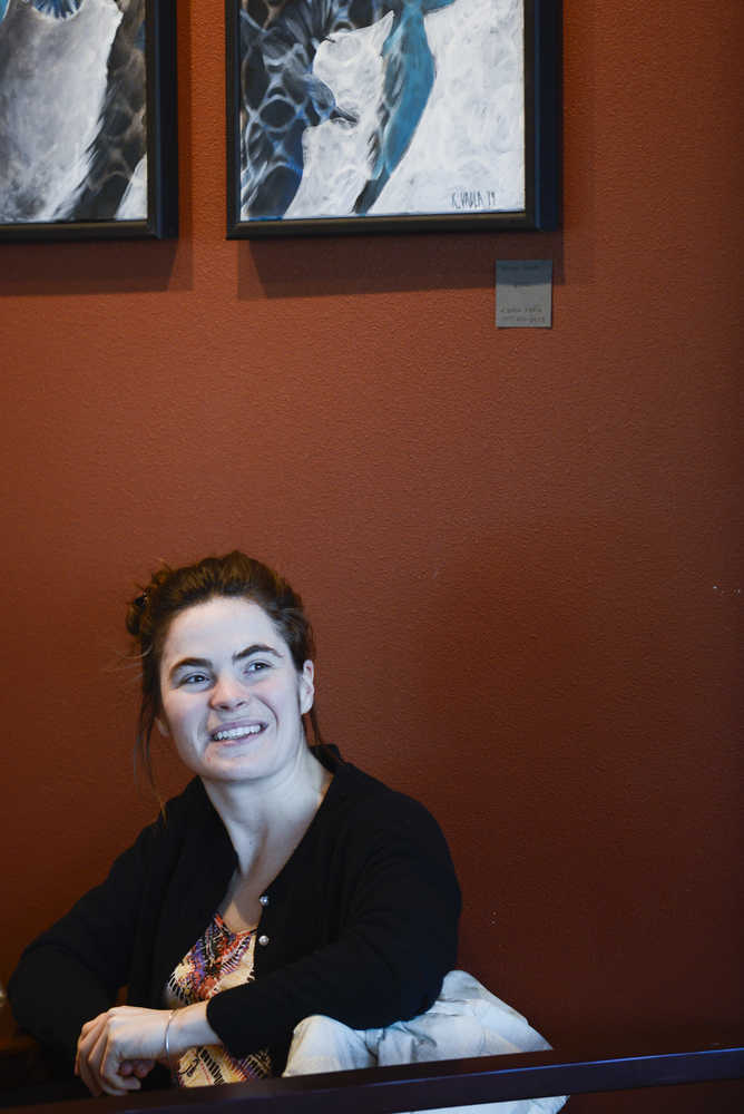 Photo by Rashah McChesney/Peninsula Clarion Kaitlin Vadla looks at her paintings while talking to a reporter on Wednesday Jan. 28, 2015 at The Flats Bistro in Kenai, Alaska.