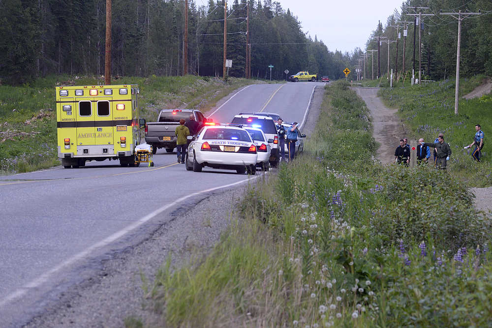 Photo by Rashah McChesney/Peninsula Clarion In this June 26, 2013 file photo, Alaska State Troopers and Nikiski paramedics respond to a standoff on Miller Loop Road during an incident that was characterized as an attempted murder. A group of community members in Nikiski is seeking support to form a service area board, in part because the entity could contract with law enforcement agencies to provide more police oversight in the area.
