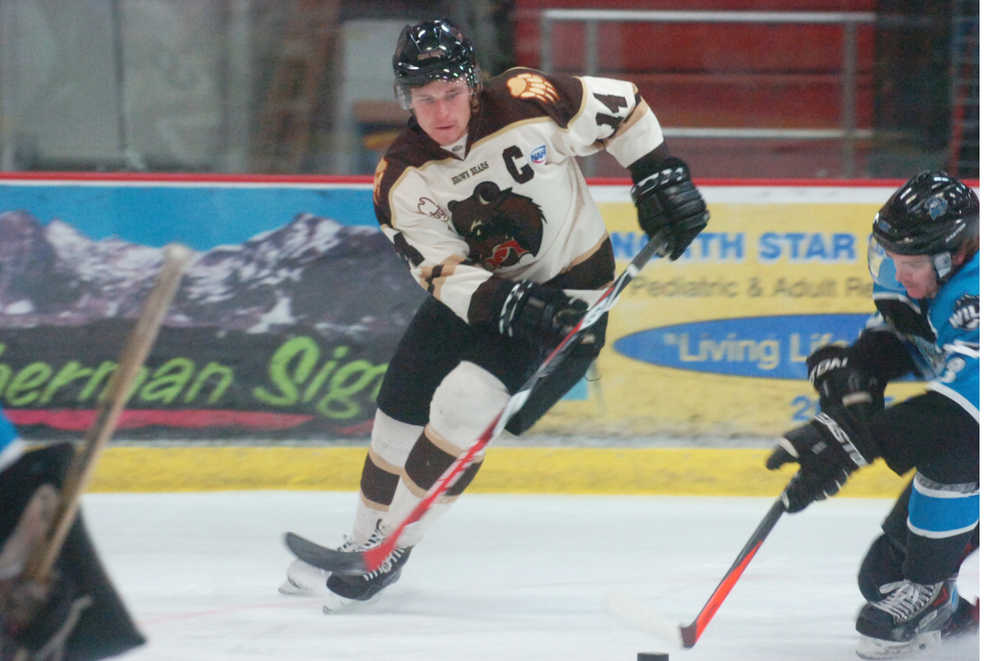 Photo by Kelly Sullivan/ Peninsula Clarion Kenai Brown Bears' defense Tyler Andrews focuses on taking control of the puck from the Wenatchee Wild Thursday, Jan. 29, 2015, at the Soldotna Regional Sports Complex in Soldotna, Alaska.