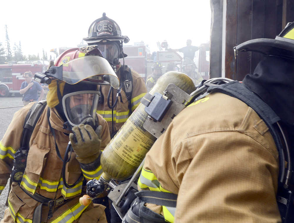 Photo by Rashah McChesney/Peninsula Clarion Firefighters queue outside of a new Central Emergency Services training facility Wednesday August 6, 2014 in Soldotna, Alaska.