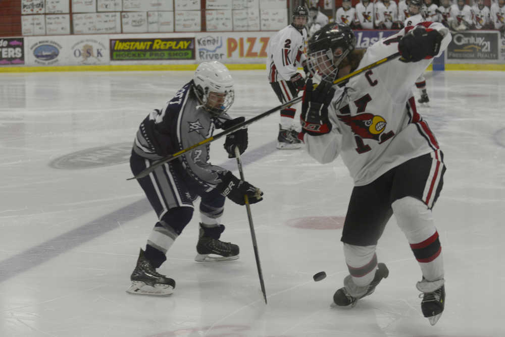 Ben Boettger/Peninsula Clarion Soldotna's Levi Hensley faces Kenai's Dalton Dosko in a hockey match on Saturday Jan. 31 at the Soldotna Sports Center.