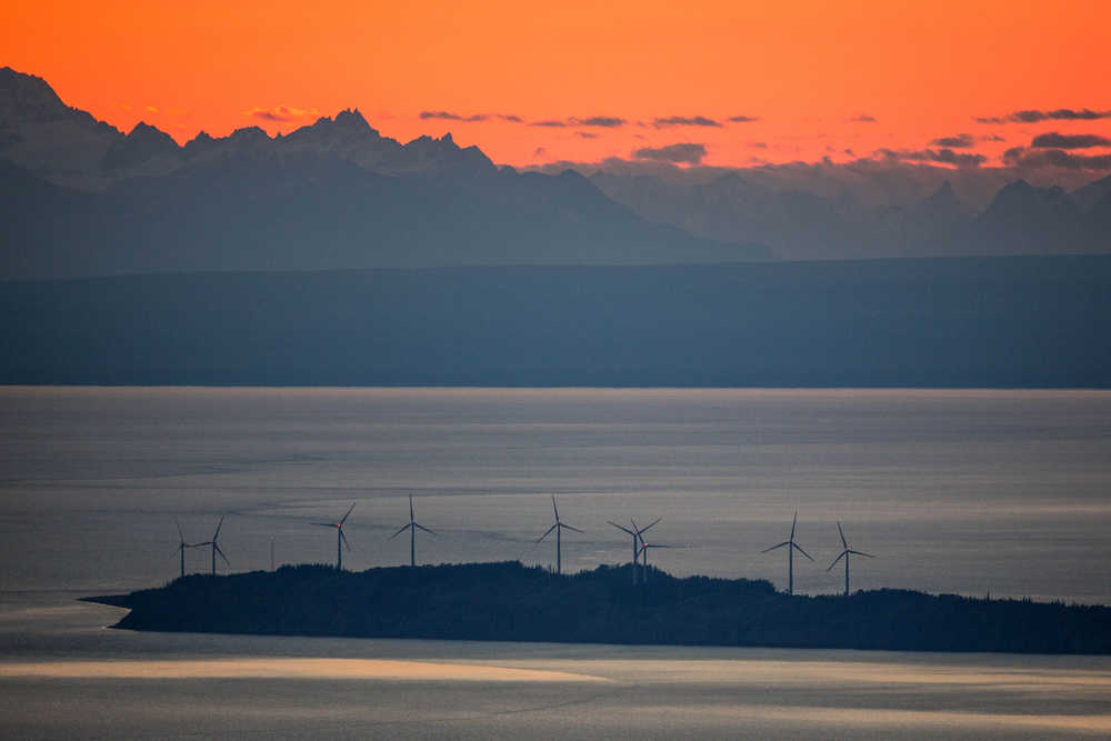 In this photo taken Sept. 24, 2014, wind turbines spin on Fire Island at sunset just off shore from Anchorage, Alaska. Plans to add turbines to the Fire Island Wind project were suspended this month when the project ran into a hitch: No one wants to buy the power. (AP Photo/Alaska Dispatch News, Loren Holmes)