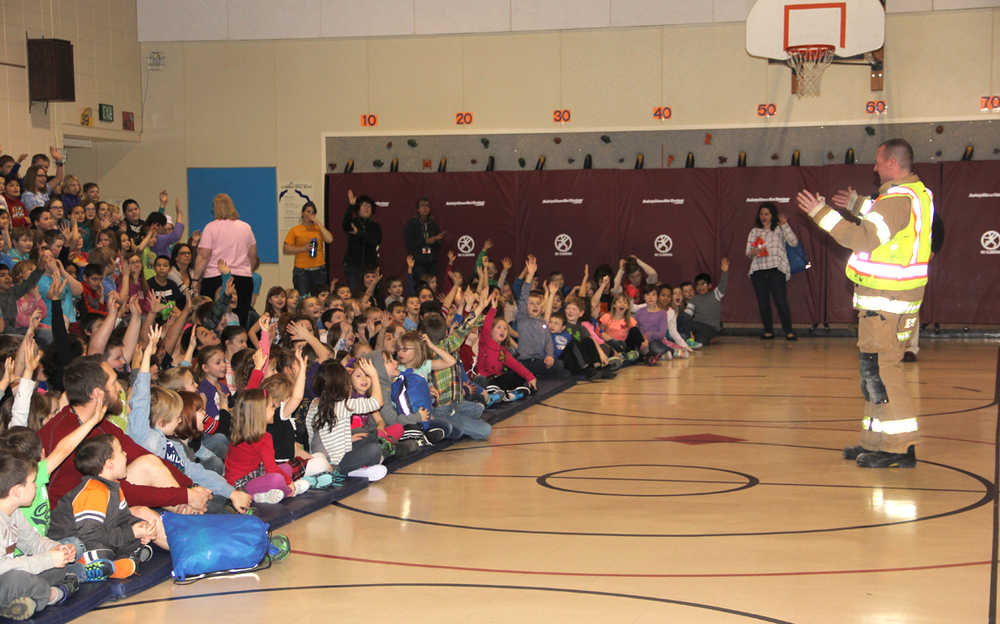 Brad Nelson of CES talk's safety to kids at Redoubt Elementary.