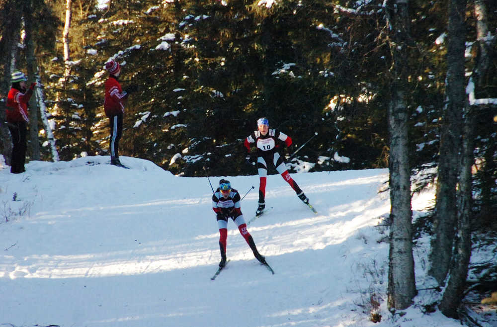 Photo by Joey Klecka/Peninsula Clarion Kenai Central freshmen Addison Gibson and Riana Boonstra crest a hill on their way to completing the first lap of Friday's Kenai Peninsula Borough ski championships, held at the Tsalteshi Trails in Soldotna.