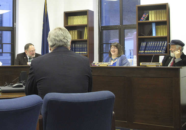Reps. Wes Keller, from left to right rear, Harriet Drummond and Paul Seaton, members of the House Education Committee, laugh during a hearing on a bill that would require Alaska school districts to teach American constitutionalism, on Friday, Feb. 6, 2015, in Juneau, Alaska. Also pictured is Keller's aide Jim Pound, foreground. Alaska lawmakers are considering a bill that would require school districts to teach American constitutionalism, the latest of several state government measures across the U.S. aimed at civics education. The House Education Committee heard Friday from members of the public who supported the bill, including some former educators. (AP Photo/Molly Dischner)