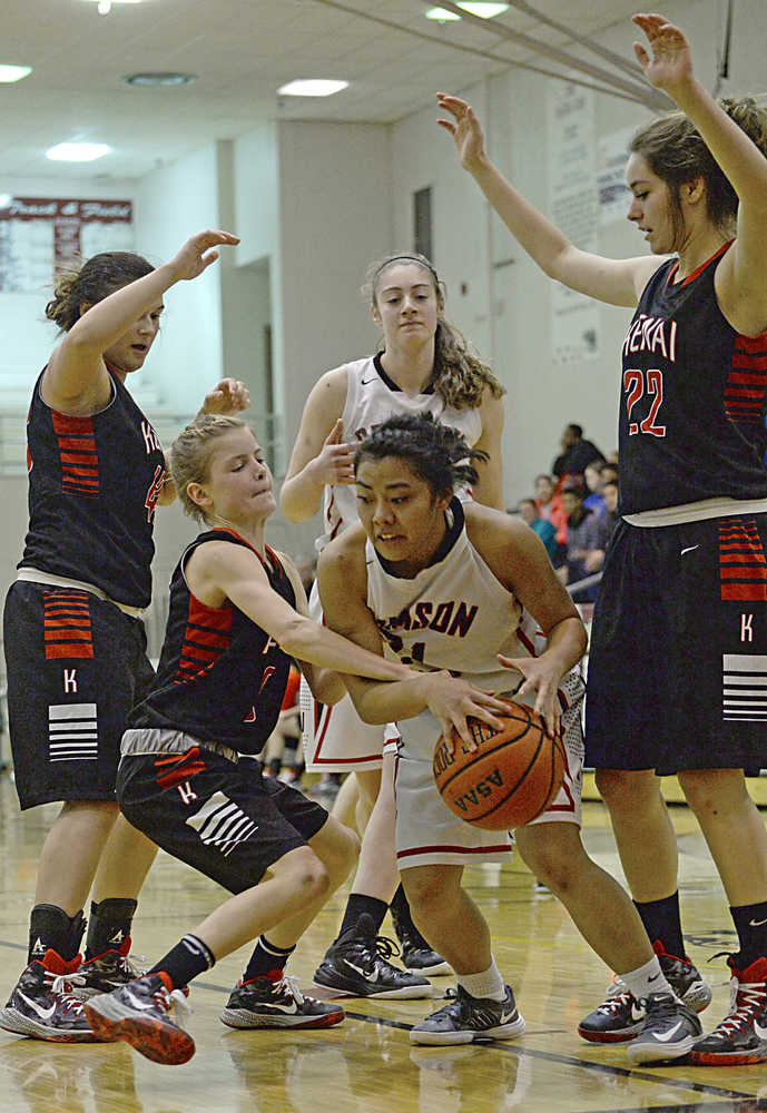 Kenai's Allie Ostrander fights for a ball with Juneau-Douglas' Rachelle Roldan as the Kardinals' Sarah Every and Alexis Baker (22) and Crimson Bears Cassie Dzinich look on during the Kardinals' 34-16 win over the Crimson Bears on Thursday in Juneau.