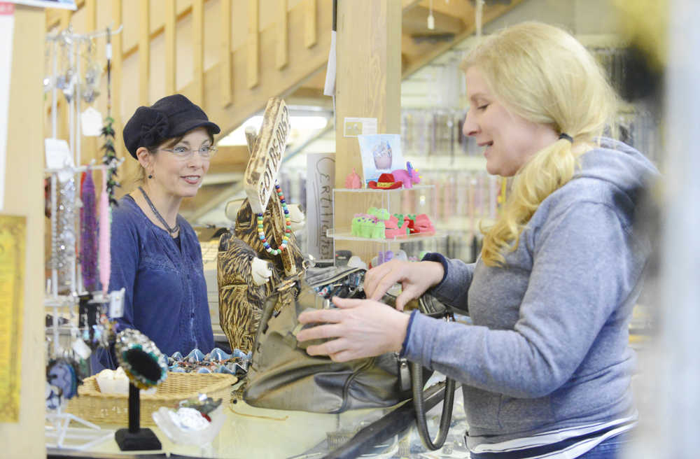Photo by Kelly Sullivan/ Peninsula Clarion Elizabeth Ward, who owns 'Bead It' with her husband Jimmy Ward, chats with Amiel Severson Monday, Feb. 16, 2015, in Soldotna Alaska. Severson said she comes consistently but refers to herself as an "irregular" customer.