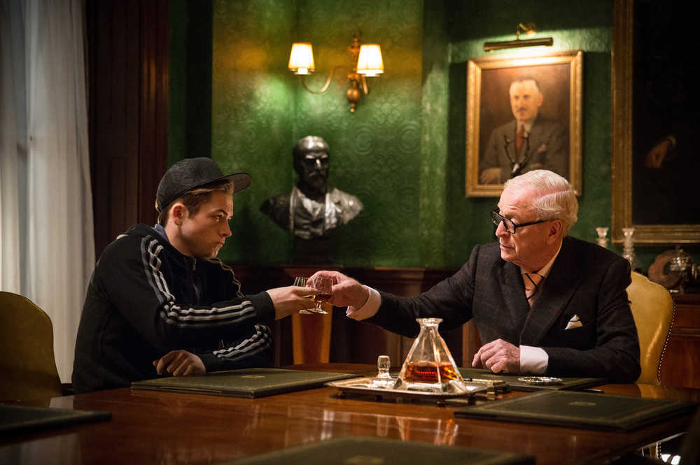 In this image released by 20th Century Fox, Taron Egerton, left, and Michael Caine appear in a scene from "Kingsman: The Secret Service." (AP Photo/20th Century Fox, Jaap Buitendijk)