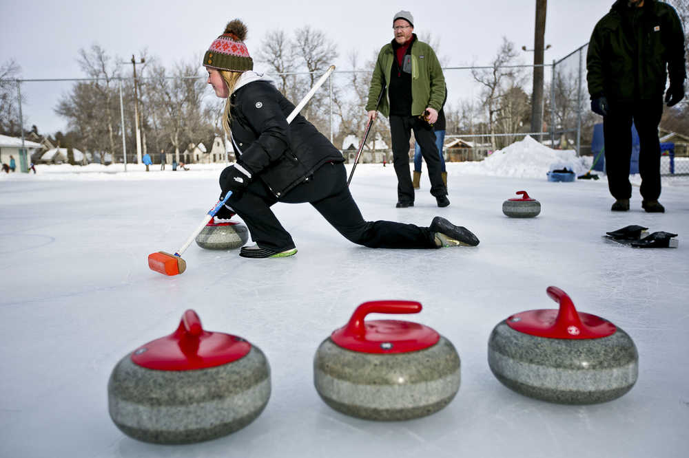 ADVANCE FOR USE MONDAY, FEB. 16 - In this photo taken Jan. 17, 2015, curling enthusiasts participate in a curling clinic hosted by the Bozeman Parks and Recreation Department at Southside Park in Bozeman, Mont.. Participants learn the basics of the game and help raise interest in the sport. (AP Photo/Bozeman Daily Chronicle, Adrian Sanchez-Gonzalez)