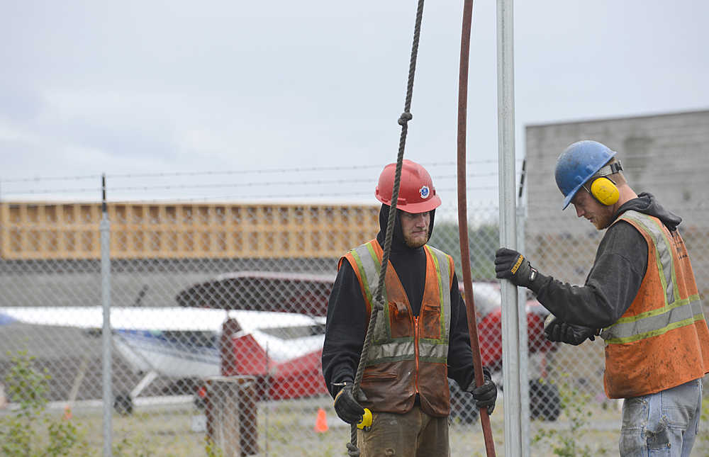 Photo by Rashah McChesney/Peninsula Clarion  Kyle Boyles and David Fink work on a portion of the Soldotna airport expansion project Thursday July 4, 2013 in Soldotna, Alaska.