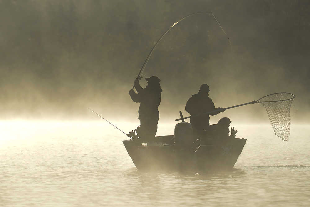 Photo by Rashah McChesney/Peninsula Clarion  Two sport anglers fish for silver salmon as the sun rises over the Kenai River Monday Sept. 1, 2014 in Soldotna, Alaska.