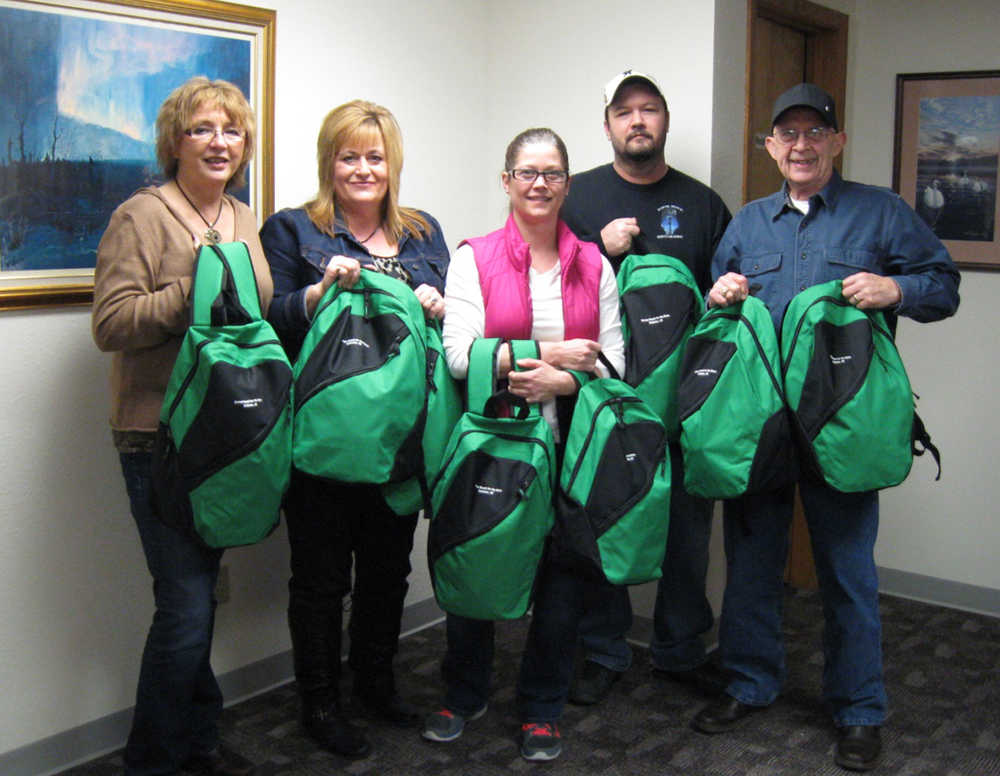 Five Star Realty's plan's for 2015 include quarterly delivery of backpacks. In December 2014 Five Star Realty delivered 15 backpacks filled with hats, gloves, sweatshirts, school supplies and individually packed food items. Above, Sharilyn Erickson, Carey Hart, Heidi Meehan, Matt Davis and Carl Lewis of Five Star Realty prepare to deliver backpacks for the first donation of 2015 for homeless teens to KPBSD.