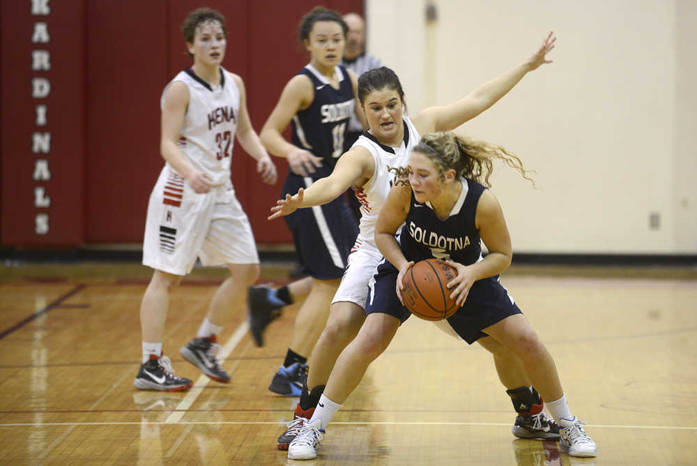 Photo by Rashah McChesney/Peninsula Clarion Soldotna's Skylar Shaw tries to get around a Kenai defender during their game on Saturday Feb. 28, 2015 in Kenai, Alaska. Soldotna won the game 40-35.