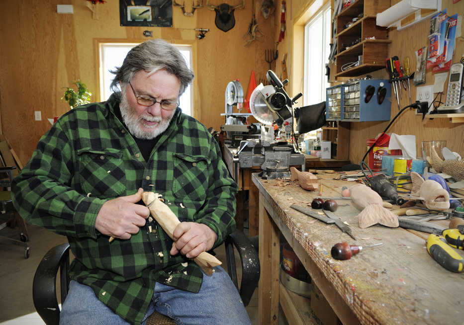 Dennis Bertram, 62, carves out a fish decoy in his workshop Tuesday, Feb. 24, 2015, in Belgrade, Minn. Bertram has been carving decoys for 35 years and spearing for 40, creating decoys from two inches long to almost 40 inches long. (AP Photo/St. Cloud Times, Jason Wachter) NO SALES