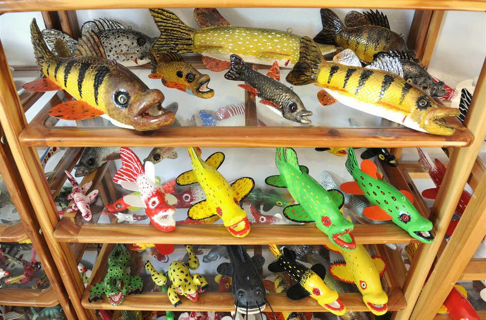 Handmade fish decoys are displayed Tuesday, Feb. 24, 2015, in Belgrade, Minn. Dennis Bertram uses glass eyes for his decoys and has been carving them for 35 years. (AP Photo/St. Cloud Times, Jason Wachter) NO SALES