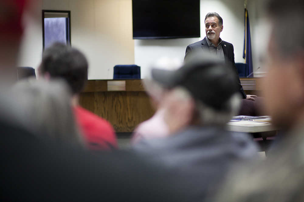 Photo by Rashah McChesney/Peninsula Clarion  Sen. Peter Micciche, R-Soldotna, goes through a powerpoint with a crowd packed into the Kenai Peninsula Borough Building during a town hall meeting on March 6, 2015 in Soldotna, Alaska.