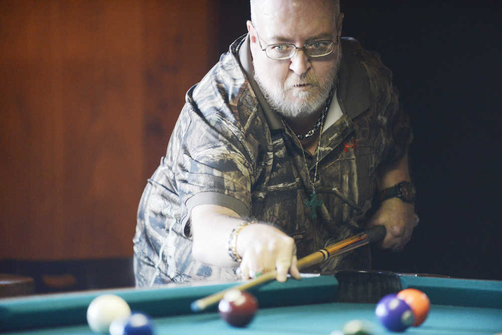 Photo by Kelly Sullivan/ Peninsula Clarion Gary Dixon lines up his shot during the 9-Ball memorial tournament for Mike Exum and John "Griz" Young Sunday, March 8, 2015, at the Alaska Roadhouse Bar and Grill in Soldotna, Alaska.