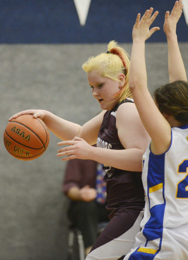 Photo by Kelly Sullivan/ Peninsula Clarion Nikolaevsk Warrior Nadejda Gordeev dribbles the ball around Cook Inlet Academy Eagle Danielle Hills Thursday at Cook Inlet Academy in Soldotna.