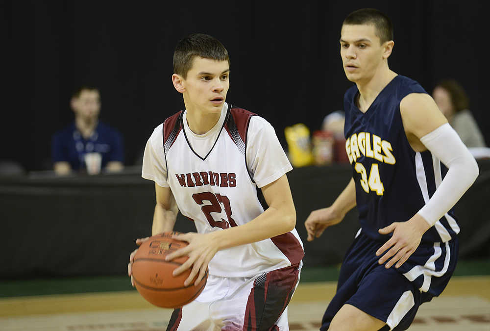 Photo by Rashah McChesney/Peninsula Clarion  Nikolaevsk's Nikit Fefelov darts around Angoon's Duncan O'Brien during their game on March 16, 2015 for the March Madness Small Schools state championships in Anchorage, Alaska.