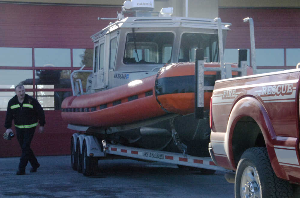 Kenai Fire Department Battalion Chief Tony Prior inspects the Fire Department's recently-acquired boat at the Kenai Fire Station on Tuesday, March 17.