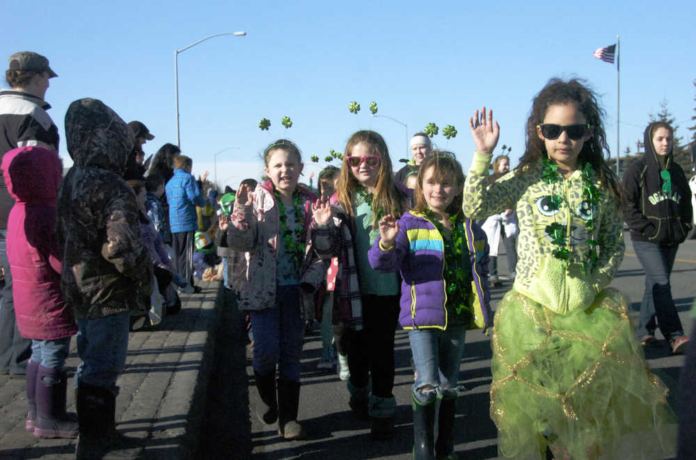 Ben Boettger/Peninsula Clarion 1st grade students from K-Beach Elementary School wave to the crowd during the Soldotna St. Patrick's Day parade at the Kenai Spur Highway on Tuesday, March 17.