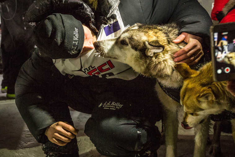 Dallas Seavey, the 2015 Iditarod Trail Sled Dog Race champion poses with his lead dogs Hero, left, and Reef in Nome, Alaska on Wednesday, March 18, 2015.   Seavey won his third Iditarod in the last four years, beating his father, Mitch, to the finish line after racing 1,000 miles across Alaska. (AP Photo/Alaska Dispatch News, Loren Holmes)