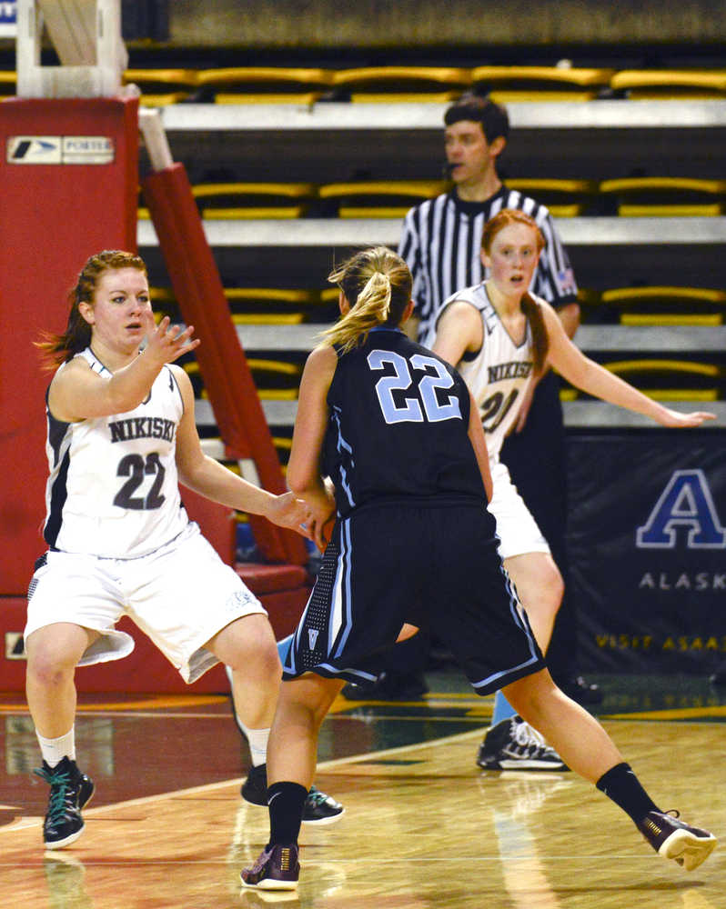 Photo by Rashah McChesney/Peninsula Clarion Nikiski's Avery Kornstad blocks Valdez's Veronica Hursh during their March Madness large school state tournament game on March 19, 2015. Valdez won 47-33.