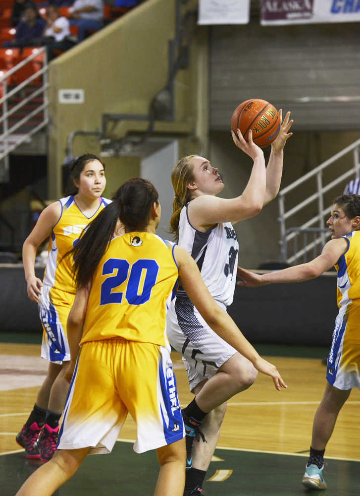 Joey Klecka/Peninsula Clarion Nikiski senior Chena Litzen drives the lane for a layup midway through the third quarter Friday against Bethel at the Sullivan Arena. The Bulldogs won 37-22 to advance to Saturday's fourth-place game against ACS.