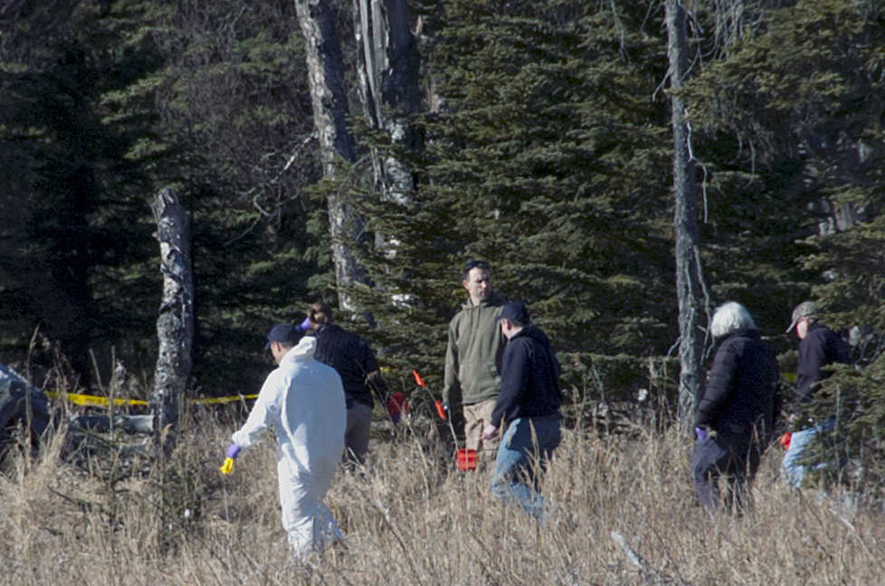 Photo by Rashah McChesney/Peninsula Clarion  A Kenai police officer walks down a trail leading to a temporary camp where police and Federal Bureau of Investigations personnel  on Sunday March 22, 2015 are working to identify remains of what Kenai Police believe to be a family who have been missing for nearly 10 months from their Kenai, Alaska home. While most of the land in the immediate area is state or federally owned, the place where police and the Federal Bureau of Investigation investigators is focusing their efforts, is a privately owned parcel.