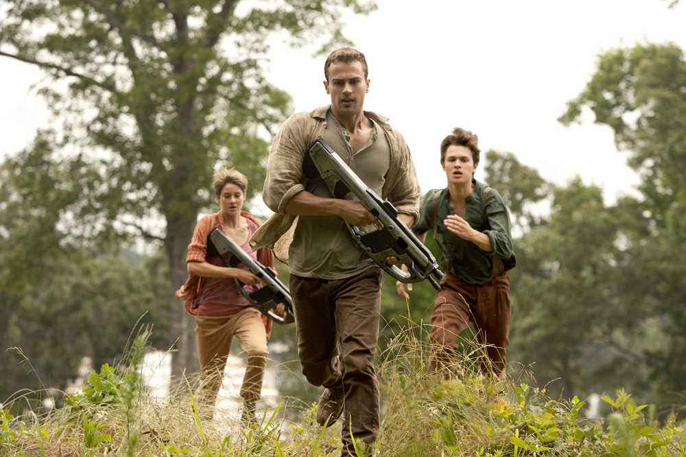 In this image released by Lionsgate, Theo James, center, Shailene Woodley and Ansel Elgort appear in a scene from "The Divergent Series: Insurgent." (AP Photo/Lionsgate, Andrew Cooper)