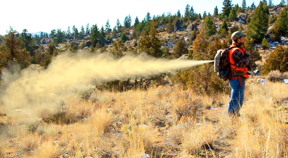 ADVANCE FOR THE WEEKEND OF MARCH 21-22 AND THEREAFTER - In an undated photo provided by BearSpray.com, Tim Lynch sprays the Bear Attack Pack backwards out of a backpack in a demonstration. The canister can be discharged much like pulling the ripcord on a parachute. The pack fits any size can of bear spray. (AP Photo/courtesy of BearSpray.com)