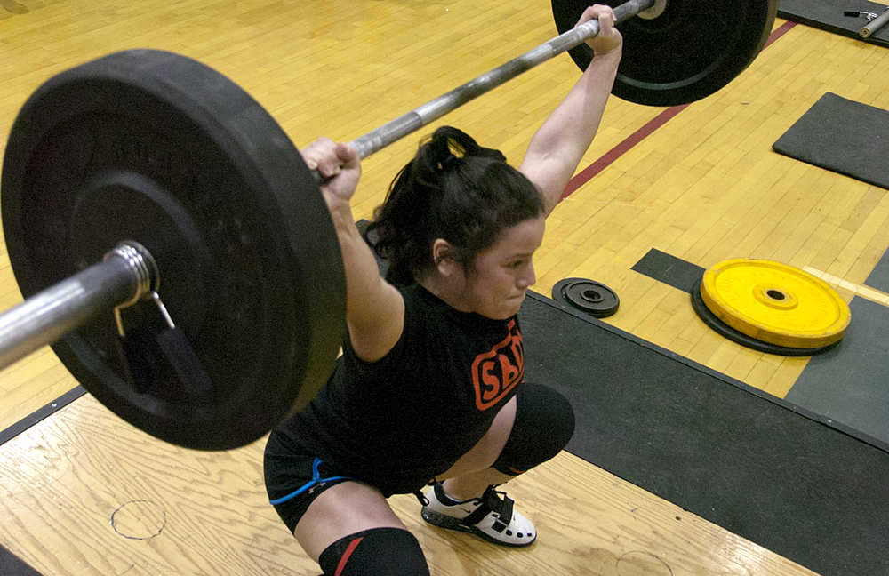 Photo by Rashah McChesney/Peninsula Clarion  Kenai Central High School's Cipriana Castellano lifts during the fourth annual Speed Strength Training lifting competition at Soldotna High School on March 26, 2015 in Soldotna, Alaska.
