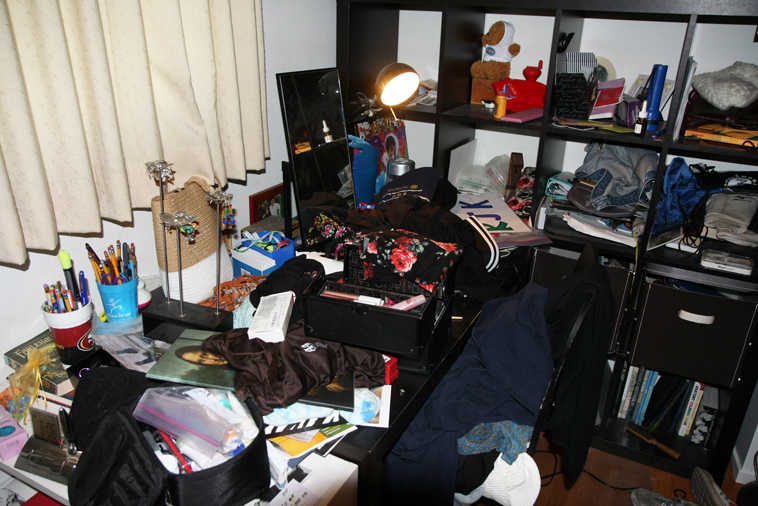 This June 2014 photo courtesy of Michael & Melissa Kaufman shows the cluttered desk belonging to their ninth-grade daughter, Rebekah.  Although the Kaufmans bought Rebekah the desk so she would have a place to study, she instead uses it as "a repository for the four outfits she tried on earlier that day and rejected," Melissa says. Rebekah prefers doing homework on her bed. (AP Photo/Michael Kaufman)