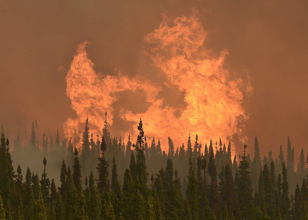 Photo by Rashah McChesney/Peninsula Clarion  In this May 24, 2014 file photo, flames from the Funny River wildfire flare up along Royce Road in Funny River. The vast majority of wildfires reported in Alaska in 2014 were human-caused. Alaska's fire season begins Wednesday and burn permits will be required by the Division of Forestry for certain types of outdoor fires.