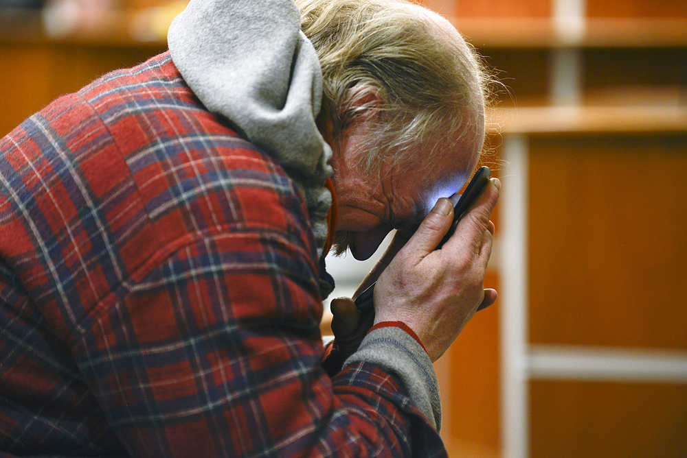 Photo by Rashah McChesney/Peninsula Clarion  Frank Roach buries his face in his hands on Wednesday April 1, 2015  after a jury found him guilty on nine counts of scheming to defraud and theft while running his nonprofit organization Alaska Veterans Outreach Boxes for Heroes in Kenai, Alaska.