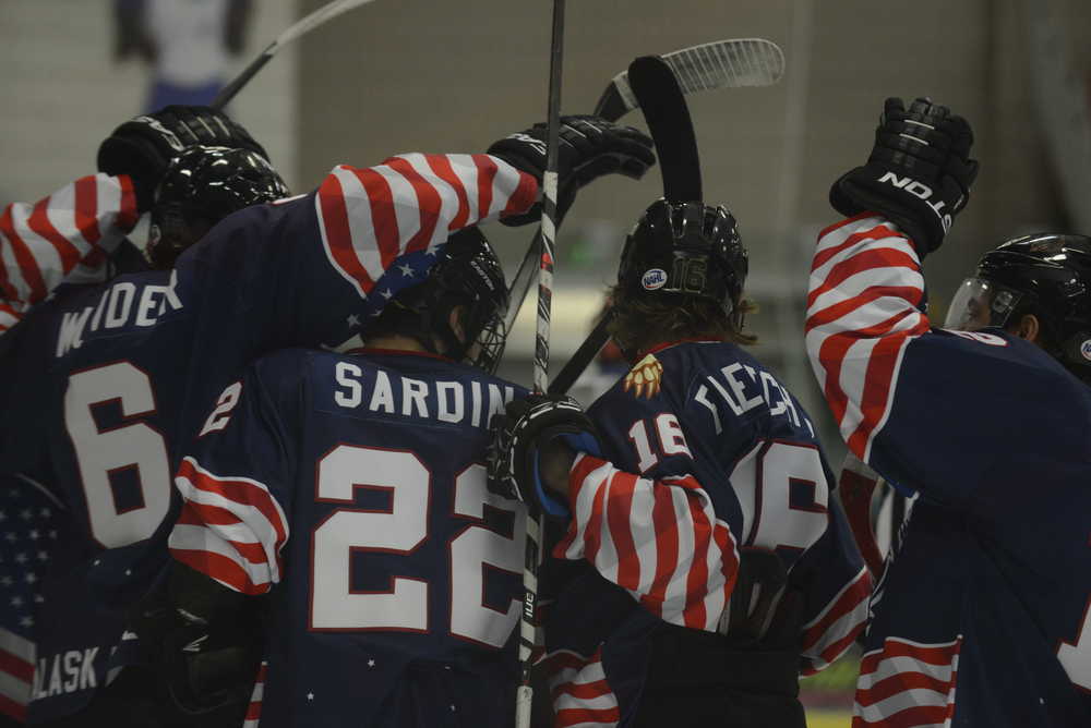 Photo by Kelly Sullivan/ Peninsula Clarion Kenai Peninsula Brown Bears' players congradulate each other after a goal, Friday, Nov. 21, 2014, at the Soldotna Regional Sports Complex in Soldotna, Alaska.