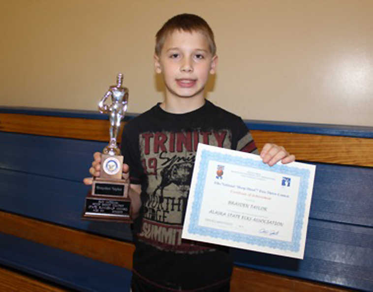 Brayden Taylor, a fourth-grade student at Soldotna Elementary, placed first in the district Elks "Hoop Shoot" free throw contest for his age group, 8-9 year-olds. The finalists went to a state competition where Brayden placed second. Evan Hatfield, district representative for the Elks Hoop Shoot, presented Brayden with his trophy recently at an assembly at Soldotna Elementary.